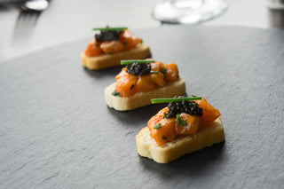 Salmon tartar with caviar on a crostini